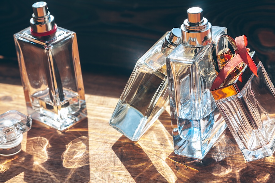 elegant perfume bottles with sunlight on wood surf 2026 03 24 00 15 54 utc
